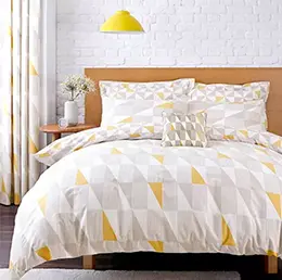 White grey and yellow Geometric Duvet Cover & Pillowcase Set on a oak kingsize bed.
